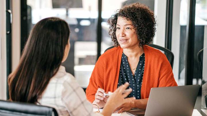 two women hold a meeting