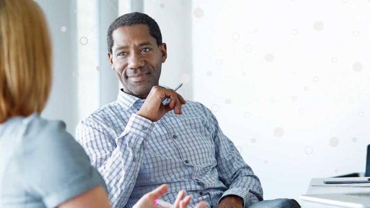 A man sits in a meeting