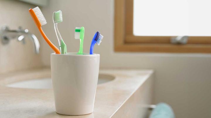 A cup filled with toothbrushes
