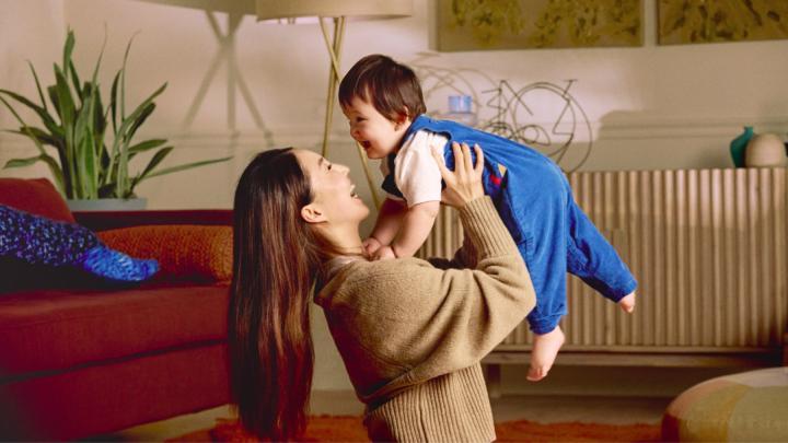 A woman plays with a baby