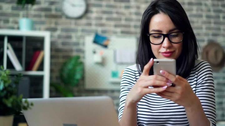A woman uses a smartphone