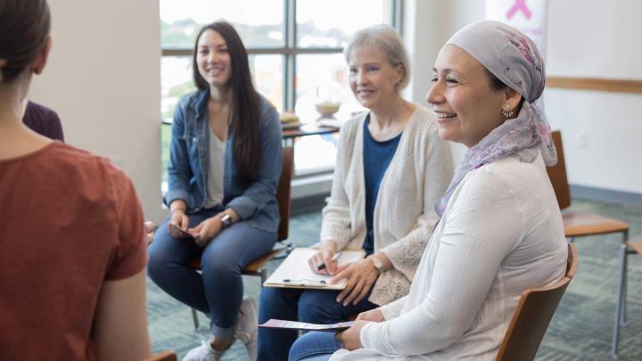 A group of patients sit together and talk