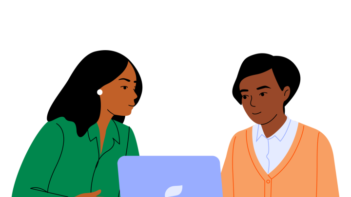 two people use a laptop computer