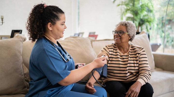 a healthcare professional takes a patient's blood pressure