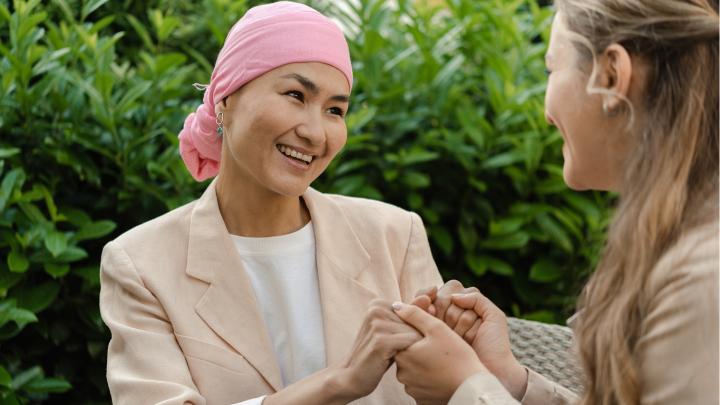Two women hold hands