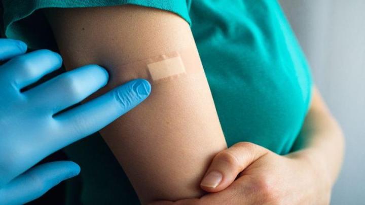woman with Band-Aid on her arm