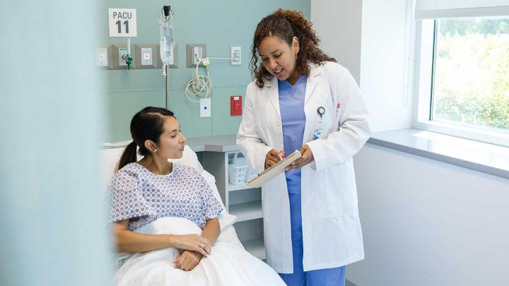 A doctor speaks with a patient in the hospital