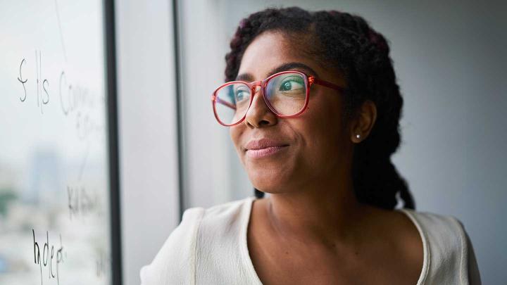 A woman looks out a window