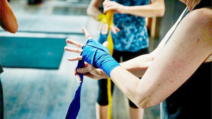 A person wraps their hand for fitness training