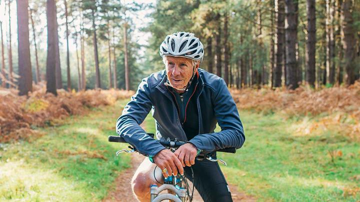 An older man rides a bike