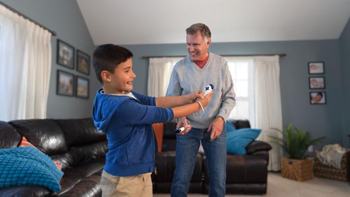 Adult and child play video games