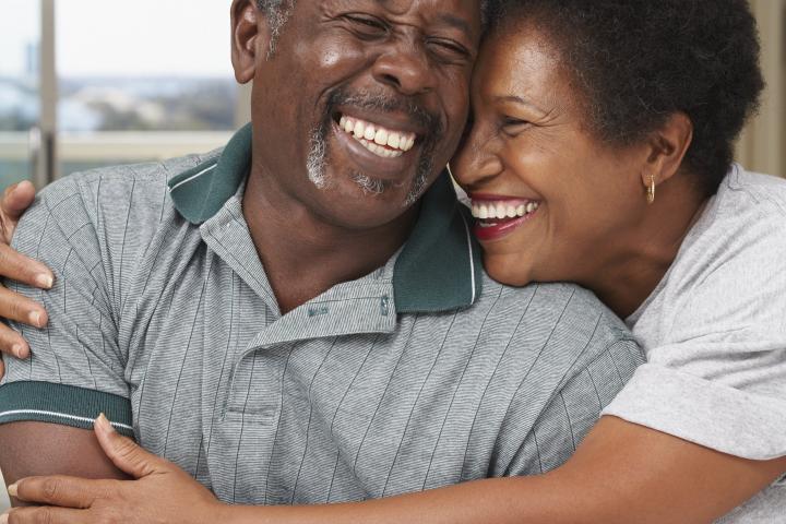 husband and wife hugging and smiling