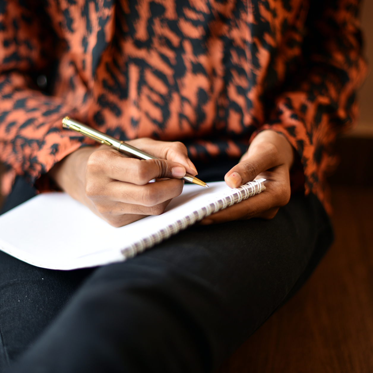 A person writes in a notebook