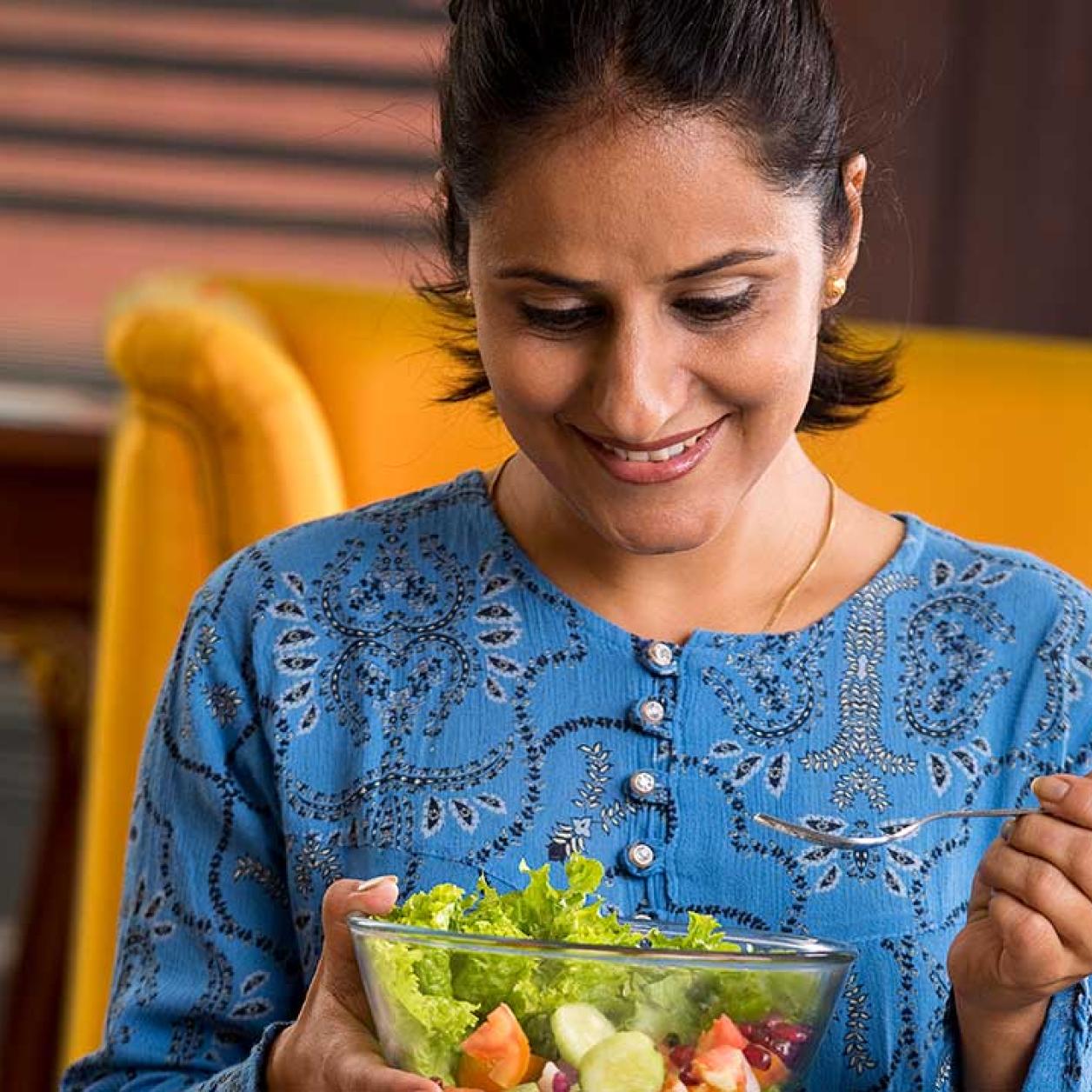 A woman eats a salad