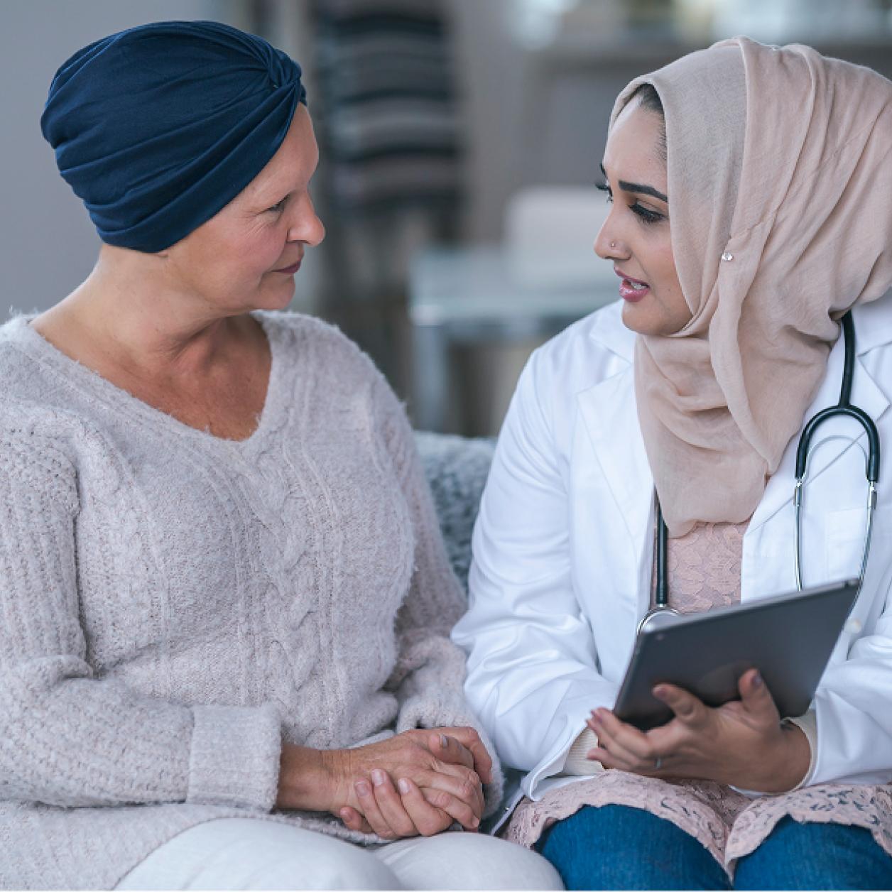 a medical professional meets with a breast cancer patient