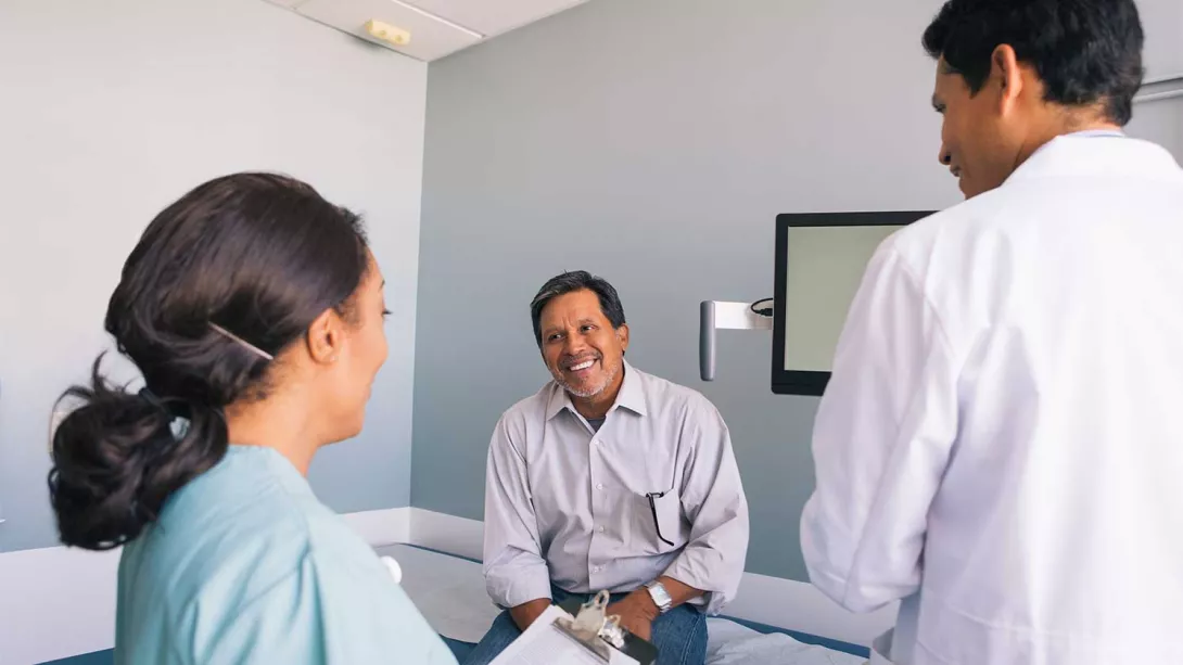 A patient meets with medical professionals