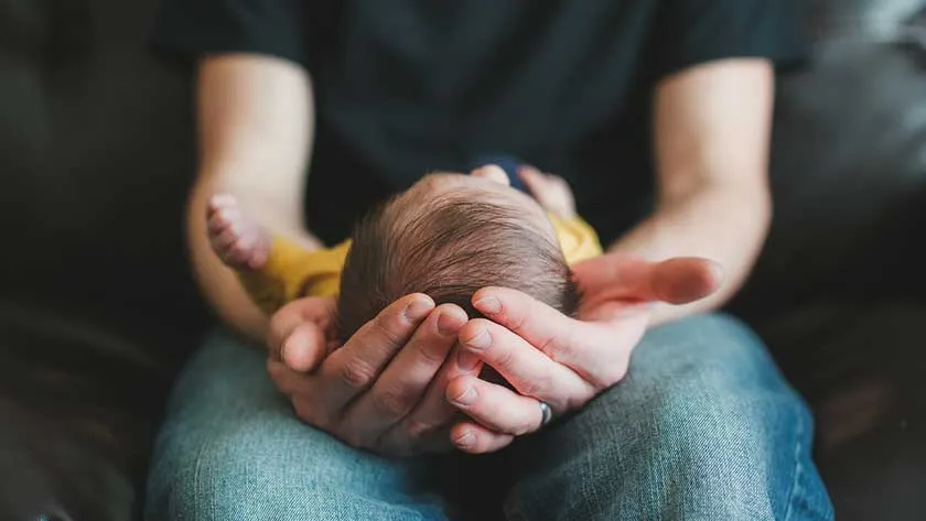 holding a newborn baby