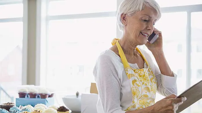 A retired woman takes a phone call