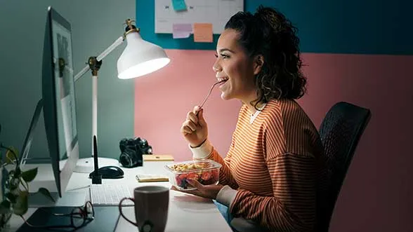 A woman takes a call on her computer