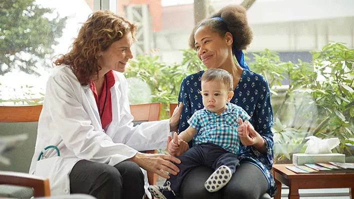 A doctor consults with a parent and baby