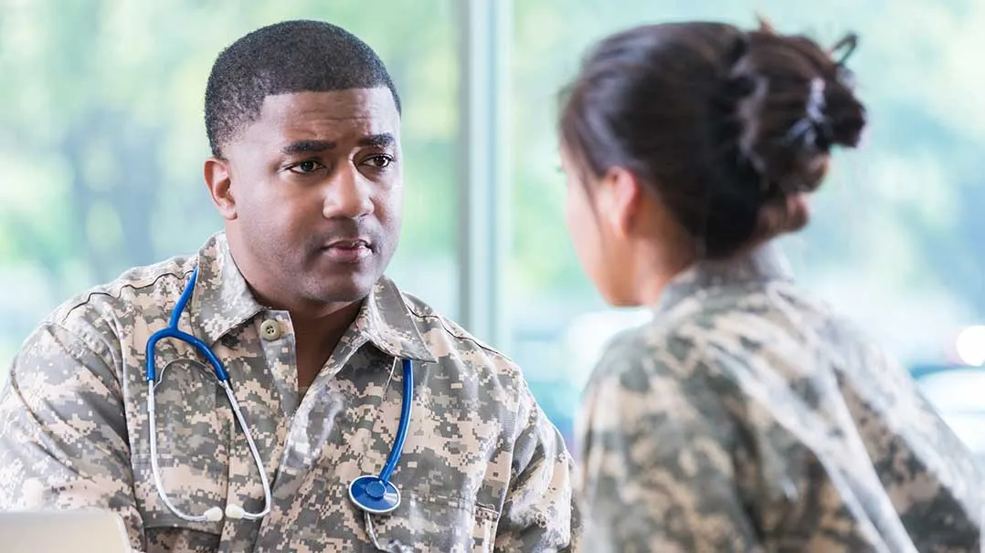 a military doctor meets with a patient