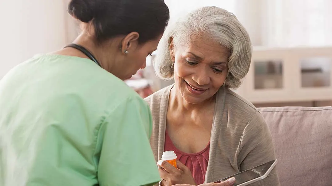 a nurse discusses medication with a patient