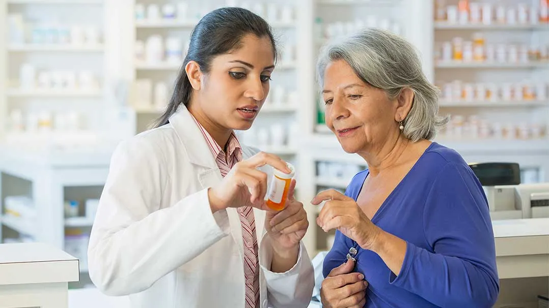 A pharmacist explains medication to a patient