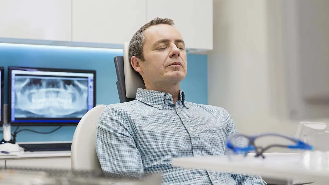 A person breathes to relax during a dental appointment