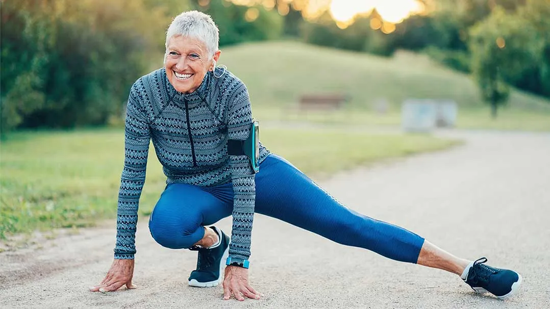 senior woman stretches before a run