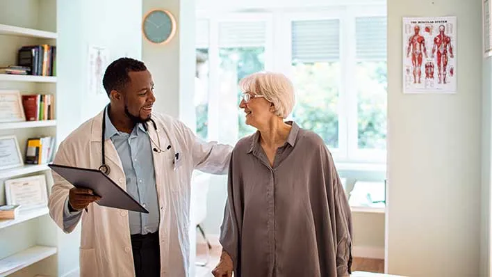 A doctor meets with an older patient